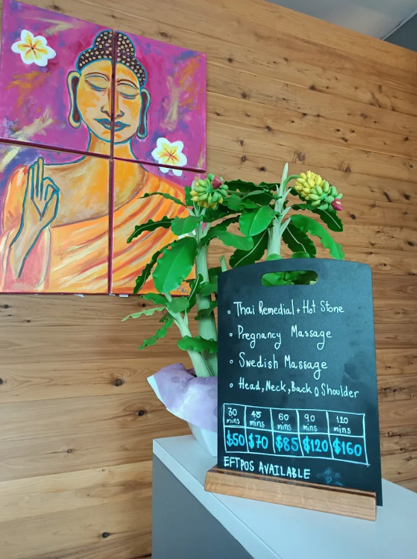 Service menu board with Buddha artwork and plants